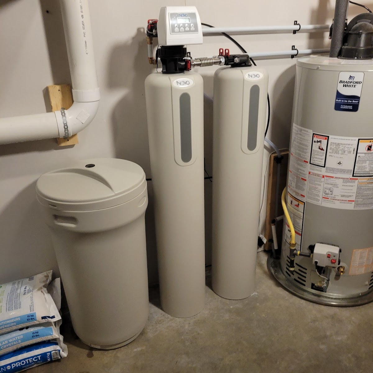 A water softener pair and gas water heater installed and ready for service